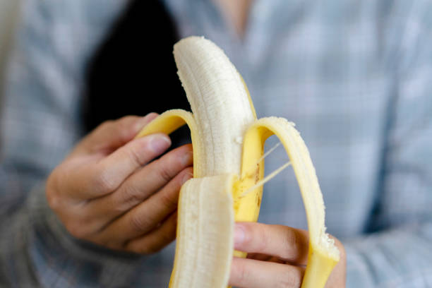 istock peeling banana to eat 1071349022