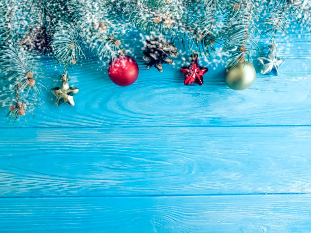istock Christmas tree branch, snow on a wooden background 1071351086