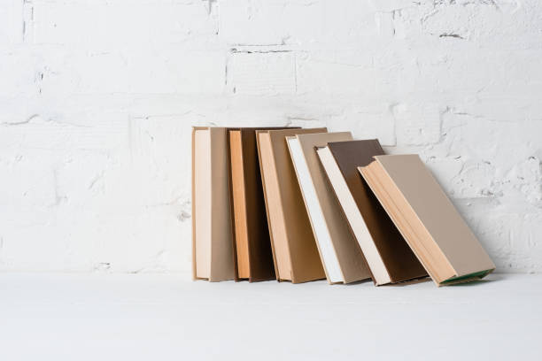 istock books on white surface near brick wall 1071351260