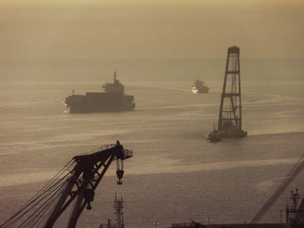 A cargo ship entering Busan Port in the dawn of the sea.