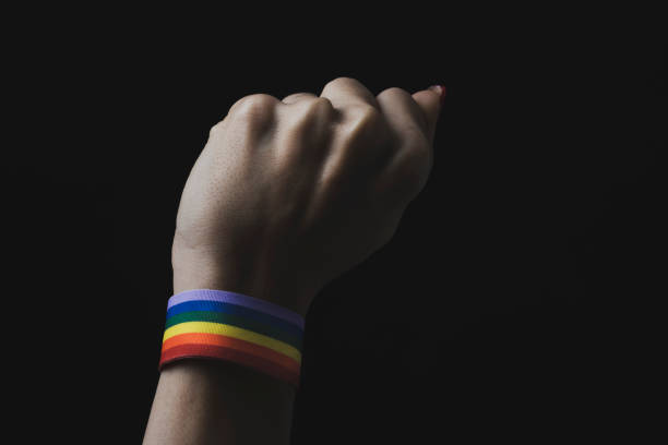 istock woman with a rainbow-patterned ribbon in his wrist 1071356106