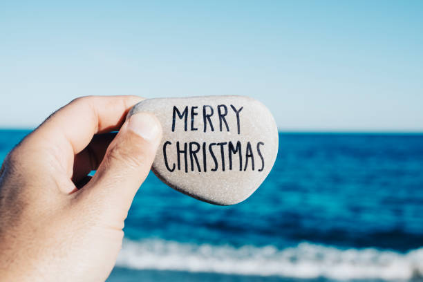 istock man holding a stone with the text merry christmas 1071356212