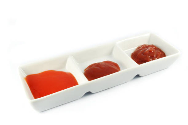 istock ketchup tomato sauce and chilli sauce in cup isolated on white background 1071356442