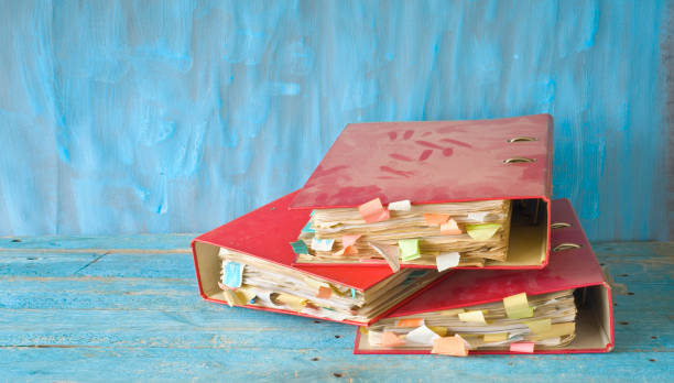 Messy file folders and grungy documents, red tape, bureaucracy concept