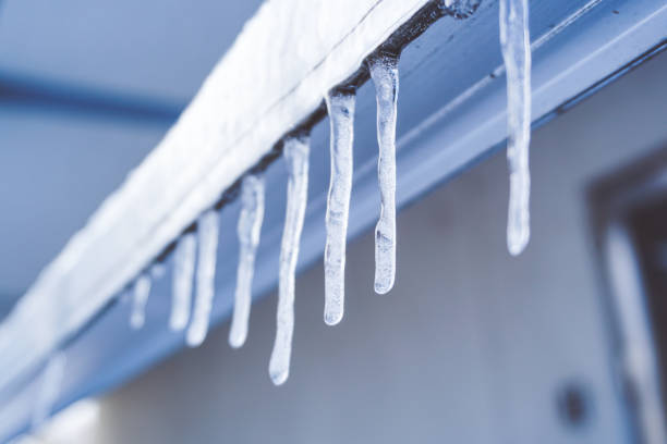 istock Icicle is hanging from a roof 1071362436