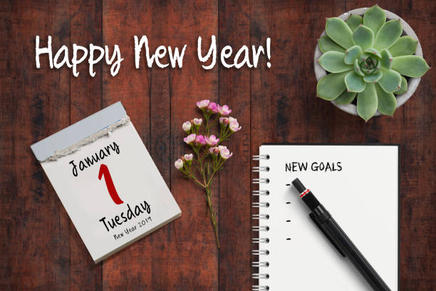 tear-off calendar with 1st of january 2019 and notebook with a checklist of "new goals" on rustic wooden background tear-off calendar with 1st of January 2019 and notebook with a checklist of "new goals" 2019 new year resolution stock pictures, royalty-free photos & images