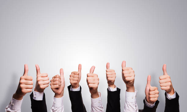 istock many thumbs up in front of grey background 1071363346