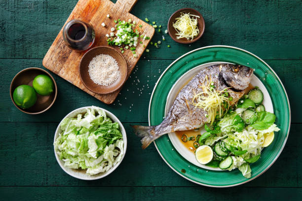 Grilled sea bream with vegetables Grilled sea bream with fresh vegetables, herbs, ginger and Chinese broth mediterranean food photos stock pictures, royalty-free photos & images
