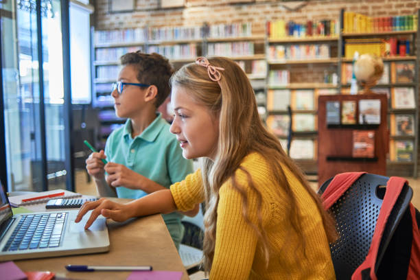 istock friends studying together in the library 1071370450