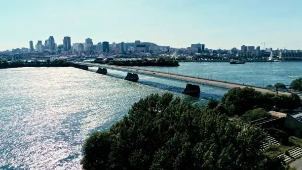 Photo of aerial drone image of montreal with bridges and skyscrapers in the background on the horizon