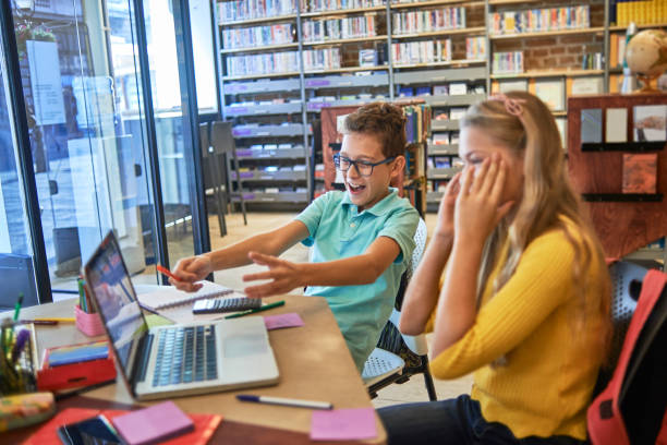 istock friends studying together in the library 1071370830