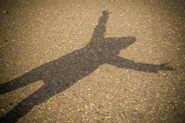 istock Woman with outstreched arms shadow for winner mindset 1071372112
