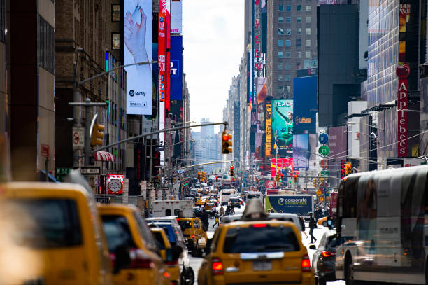 Traffic jam in Times Square during a cloudy day. Times Square is a major commercial intersection, tourist destination, entertainment center and neighborhood in the Midtown Manhattan section of New York City.