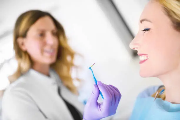 Photo of Dentist measure the interdental space with the patented probe.