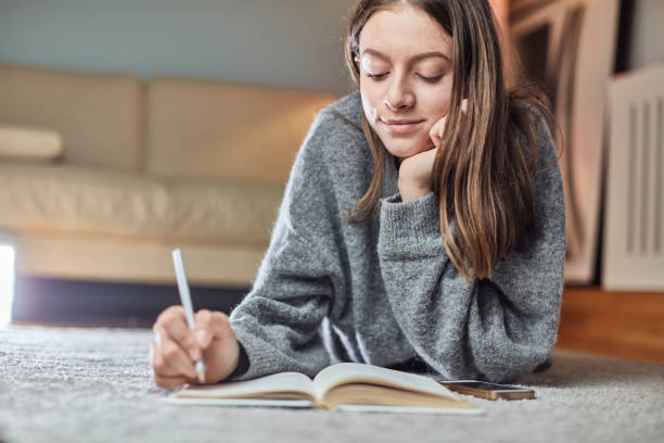 istock Seventeen year old teenager doing her homework 1071375428