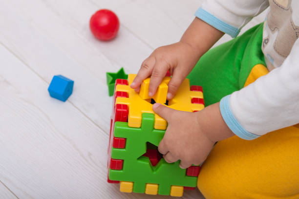 istock Toddler or child is playing with plastic shape sorter. 1071380528