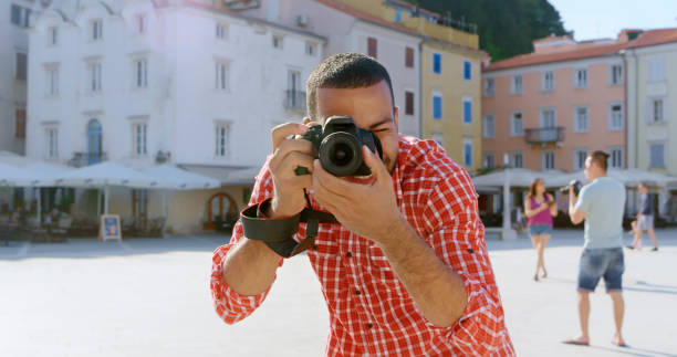 istock Man taking photo with digital camera 1071382966