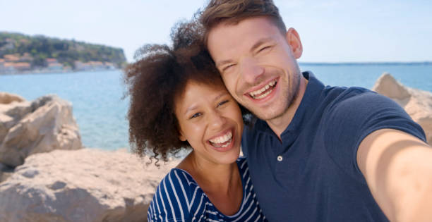 istock Friends taking selfie at beach 1071383028