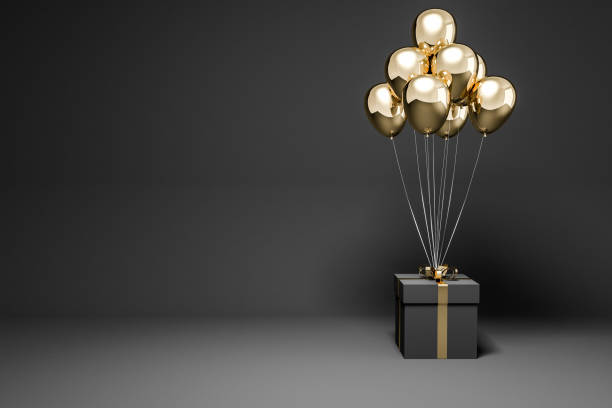 istock Black present with many gold balloons 1071385296