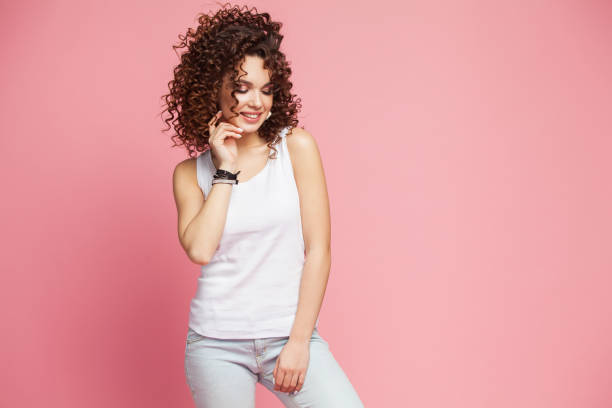 istock Image of happy young lady standing isolated over pink background. Looking camera pointing. 1071386882
