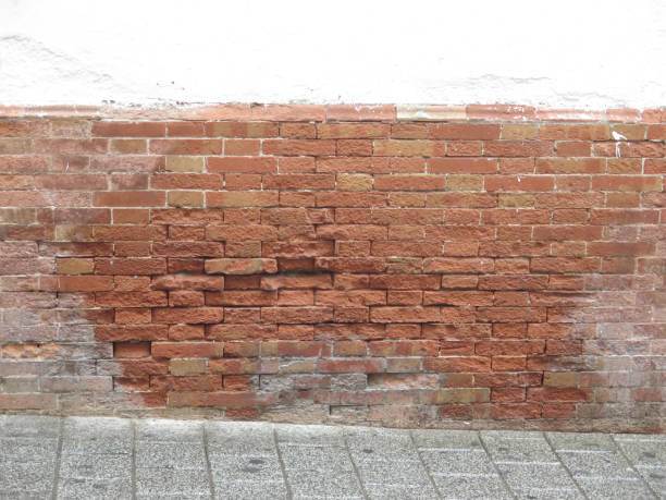 istock Exposed brick wall on village road 1071387064