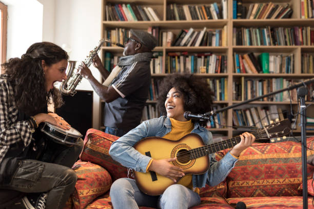 istock Musicians playing a guitar, a drum and a saxophone 1071390756