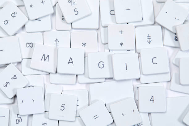Word MAGIC as keyboard letters lying on a sea of broken keyboard letters