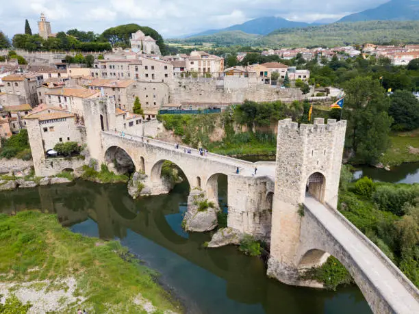View from drone of medieval Spain town of Besalu with Romanesque bridge over Fluvia river