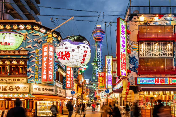 Osaka Shinsekai at Night Tsutenkaku Tower Crowded Shinsekai District, Tsutenkaku Tower in the background. Illuminated Neon Billboards at Night, Vibrant Osaka Shinsekai Cityscape. Shinsekai, Osaka, Japan, Asia osaka city photos stock pictures, royalty-free photos & images
