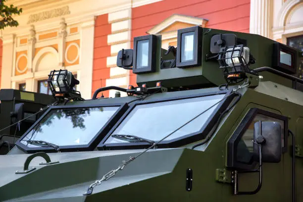 Close up of the windshield of an armored military vehicle with equipment for reconnaissance of the Ukrainian army in the city.