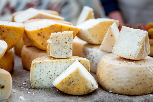 Cheese pieces for sale in an outdoors market stall, Vilalba celebration event, tradition, Lugo province, Galicia , Spain.