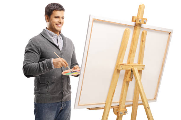istock Young man painting on a canvas 1071394150