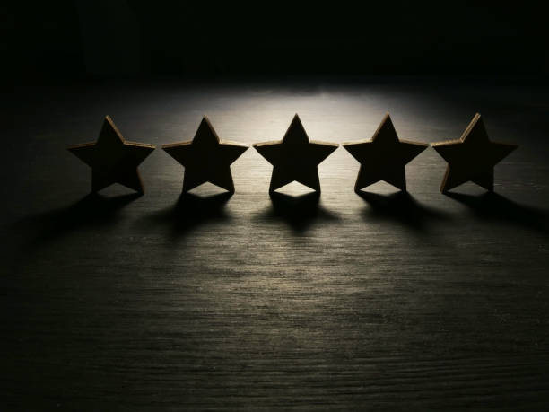 istock Five stars in the dark. Customer experience and satisfaction concept. 1071395476