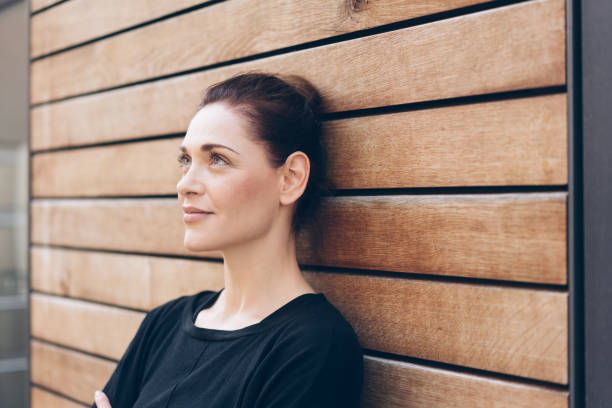 istock Thoughtful woman standing daydreaming 1071395918