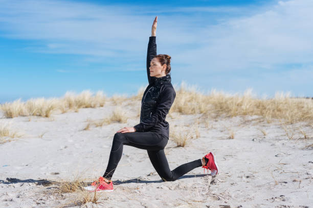 istock Healthy active woman working out on a beach 1071396520
