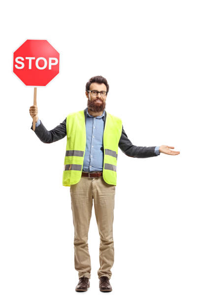 istock Man with a safety vest holding stop sign 1071396588