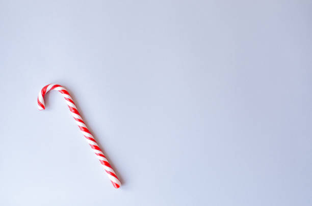 istock Caramel cane on a gray background. 1071396610