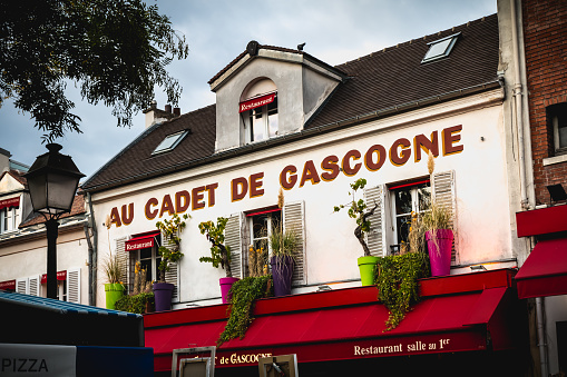 Paris, France - October 6, 2018: front of the restaurant Au Cadet de Gascogne on the Place du Tertre in the famous district of Montmartre on a fall day
