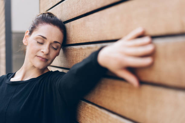 Relaxed woman feeling timber wall in sensual theme
