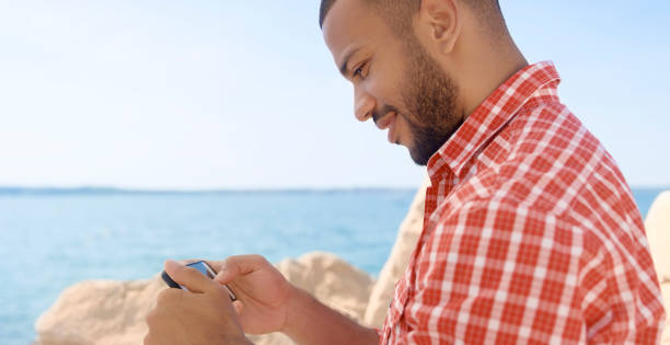 istock Man looking photos in smart phone 1071399250