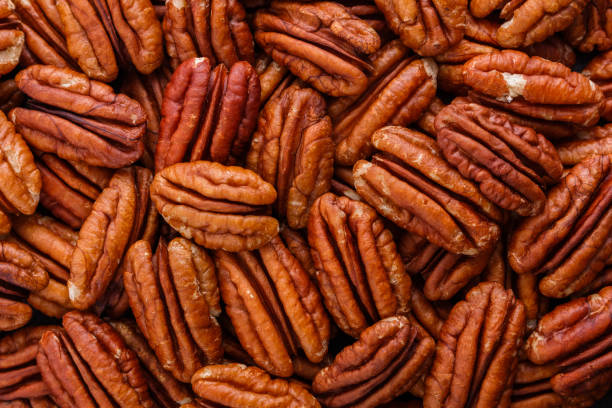 istock delicious pecan nuts on a dark stone background 1071400030