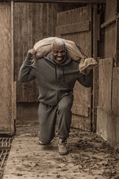 istock Middle aged black fighter working out in an abandoned farm 1071400358