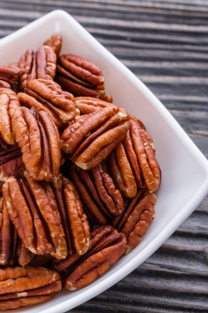 istock delicious pecan nuts on a rustic wooden background 1071402212