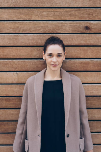 istock Attractive woman posing against a wooden wall 1071402932
