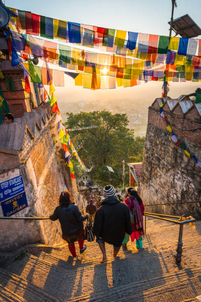 kathmandu prayer flags sunrise on swayambhunath monkey temple pilgrims nepal - swayambhunath imagens e fotografias de stock