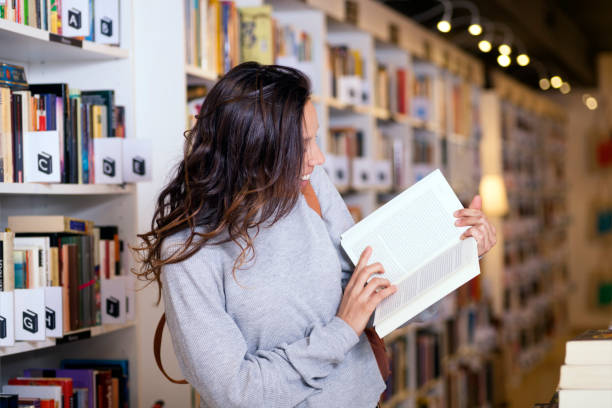 istock Woman buying books 1071409272