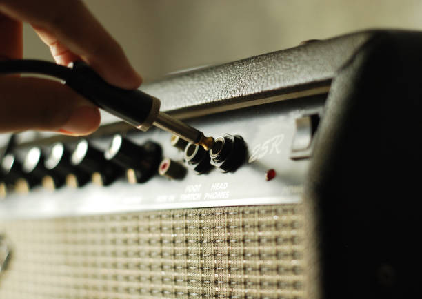 istock guitar amplifier with hand on cable audio jack 1071411246
