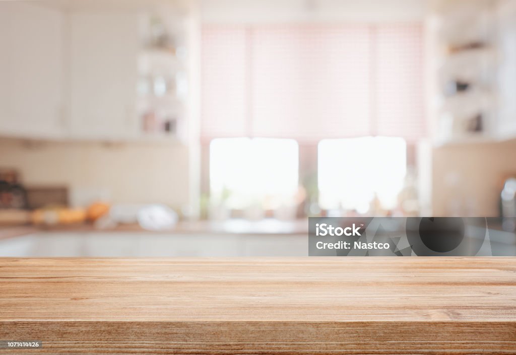 Wooden tabletop over defocused kitchen background Empty wooden tabletop over defocused kitchen background with copy space Kitchen Stock Photo
