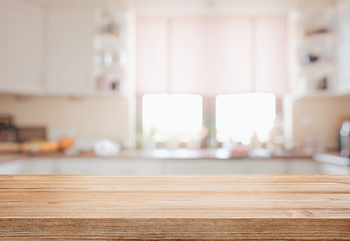 Wooden Tabletop Over Defocused Kitchen Background Stock Photo - Download  Image Now - Kitchen, Table, Backgrounds - iStock