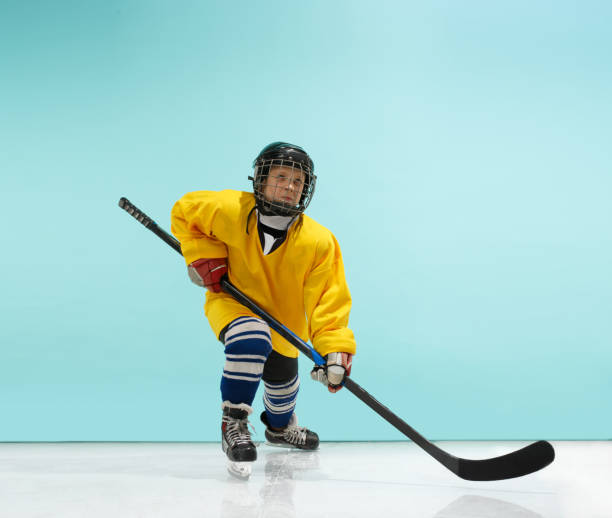 istock A hockey player with equipment over a blue background 1071415096